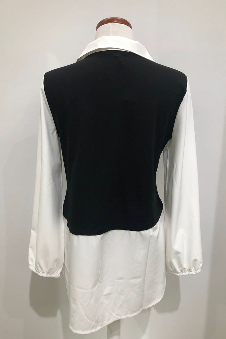 Tunique bicolore élégante, partie supérieure noire, col blanc, manches bouffantes, look chic et stylé.