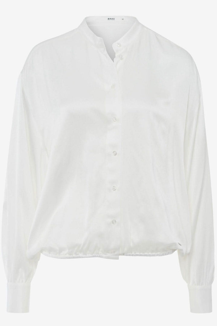 Blouse soyeuse Viv, blanche, sans col, manches bouffantes, détail élastique pour un look tendance et confortable.