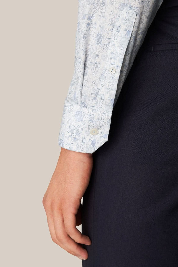 Man wearing a light blue twill shirt with a fun &
