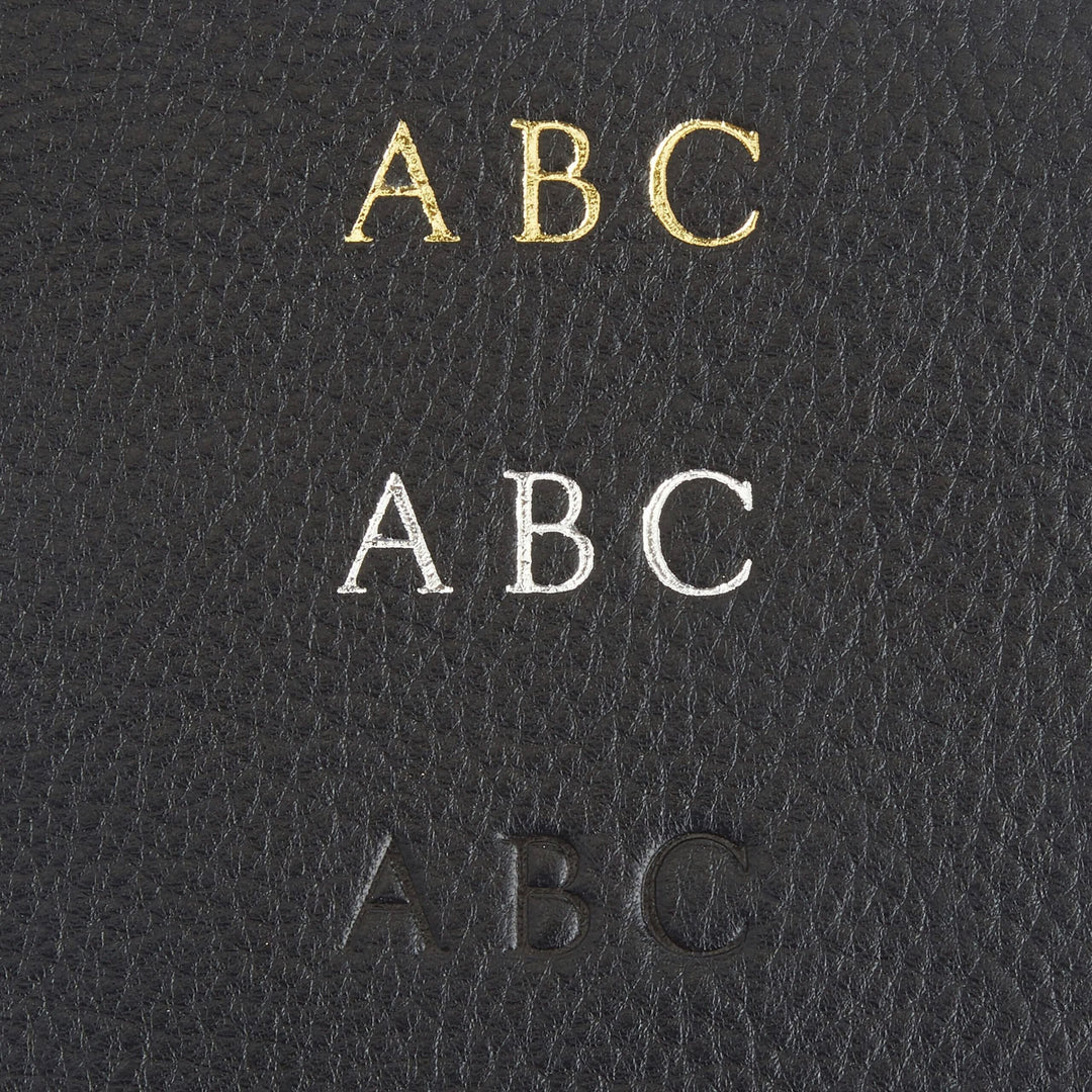 Monogrammed leather wallet showing initials ABC in gold, silver, and embossed black on full grain leather.