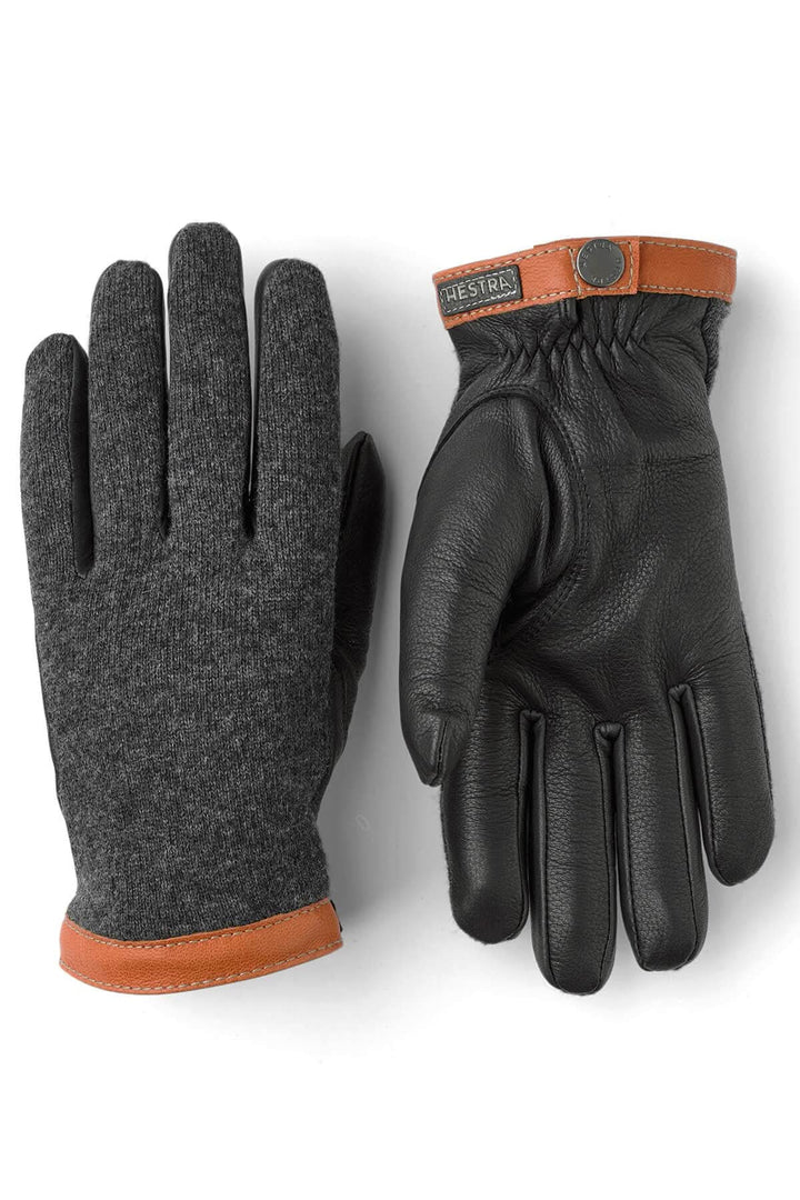 Gants en cuir noir et tricot gris avec une finition en cuir brun, offrant confort et chaleur pour l'hiver.