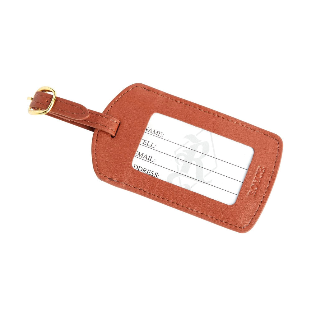 Handcrafted leather luggage tag with adjustable strap and gold tone hardware, featuring personalization options.