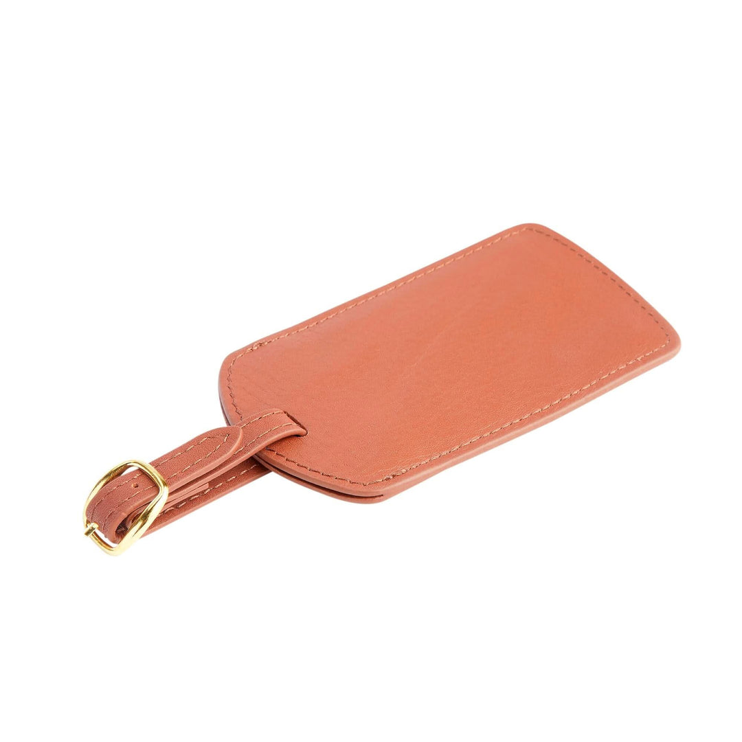 Handcrafted genuine leather luggage tag with gold tone hardware, adjustable strap, and monogram capability.