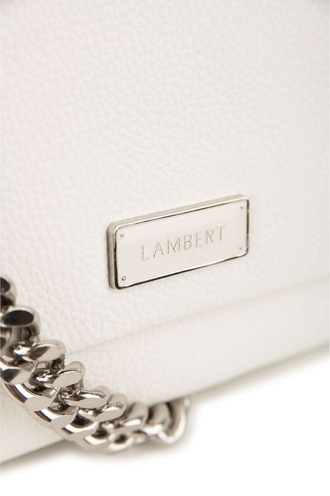 Zoom sur le sac à main blanc Lambert avec chaîne métallique et logo sur le devant.
