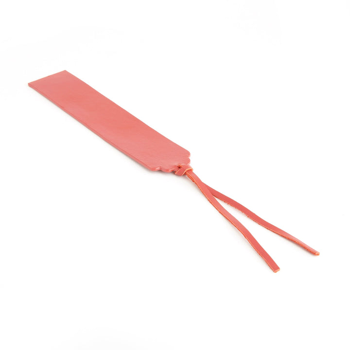 Handmade coral leather bookmark with tassels, perfect for marking pages with elegance. Personalizable with monogram.