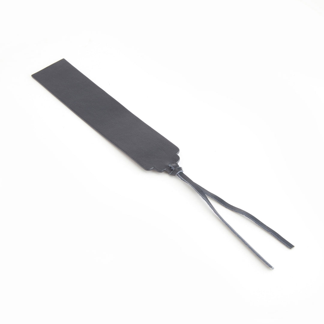 Handmade leather bookmark in black with ribbon ends, ideal for personal monogram customization.