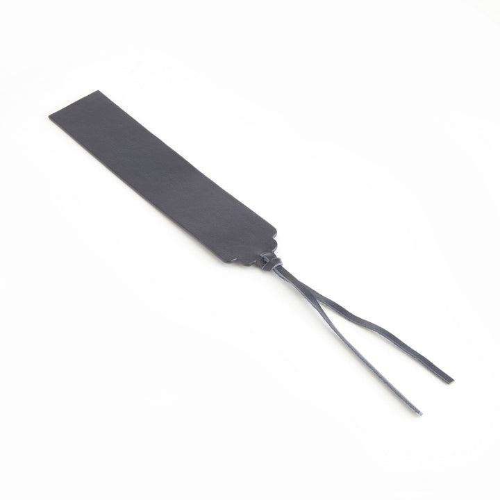 Handmade leather bookmark in black with ribbon ends, ideal for personal monogram customization.