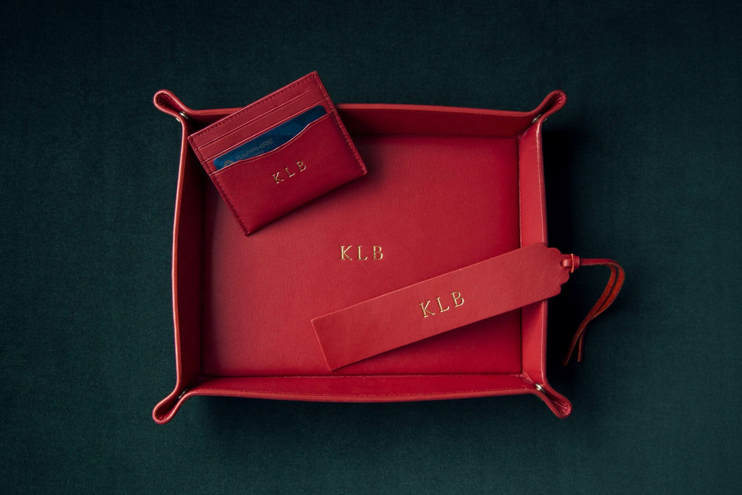 Handmade red leather bookmark and cardholder monogrammed with initials 'K.L.B.' in an elegant gift tray.