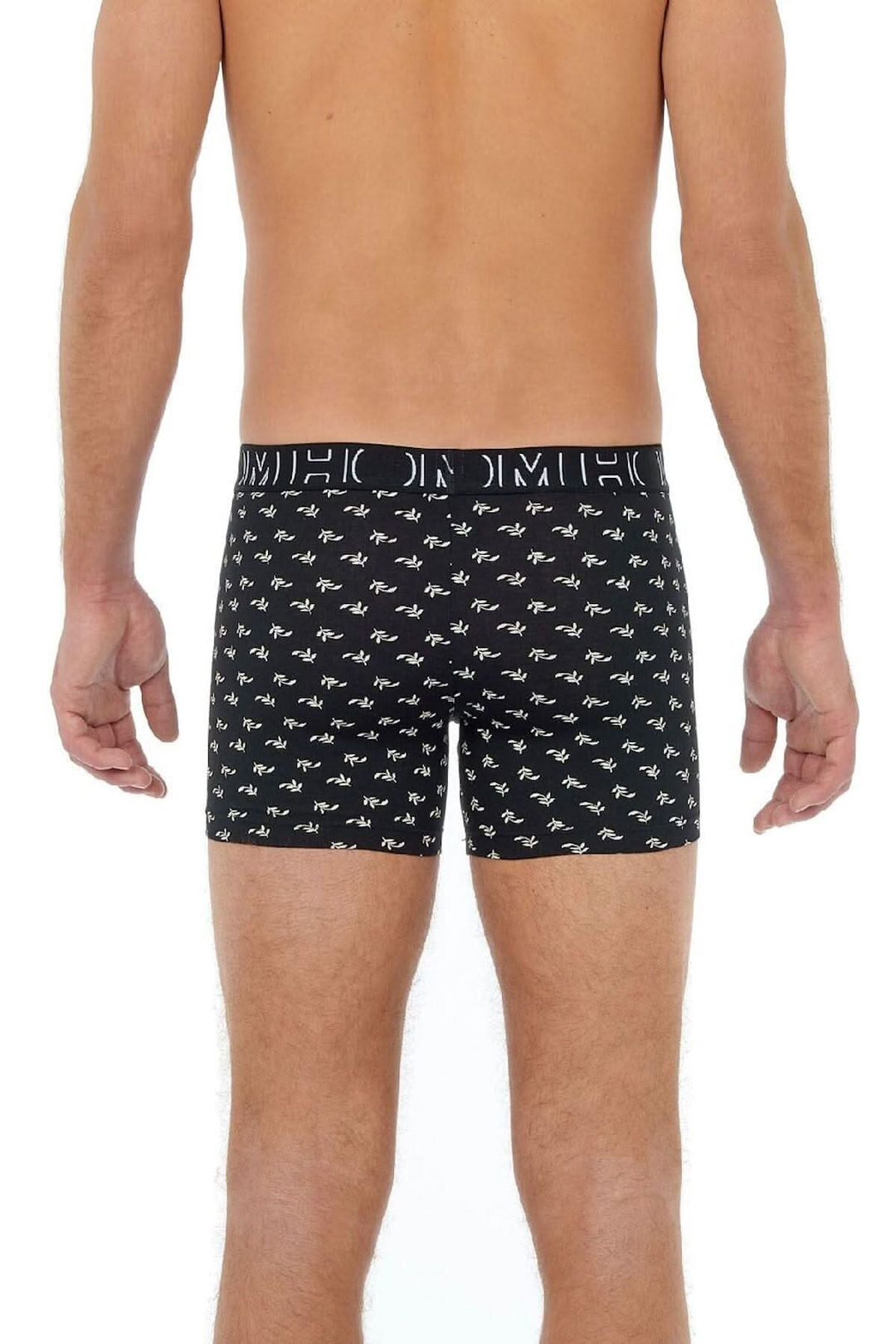 Homme portant un boxer noir avec motifs végétaux, vue arrière, en coton élasthanne, style chic.