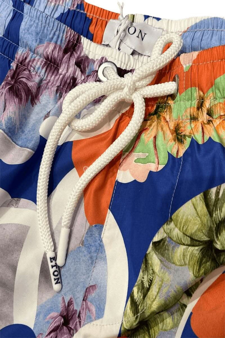 Maillot de bain multicolore avec motifs floraux et cordon de serrage, idéal pour les journées d'été.