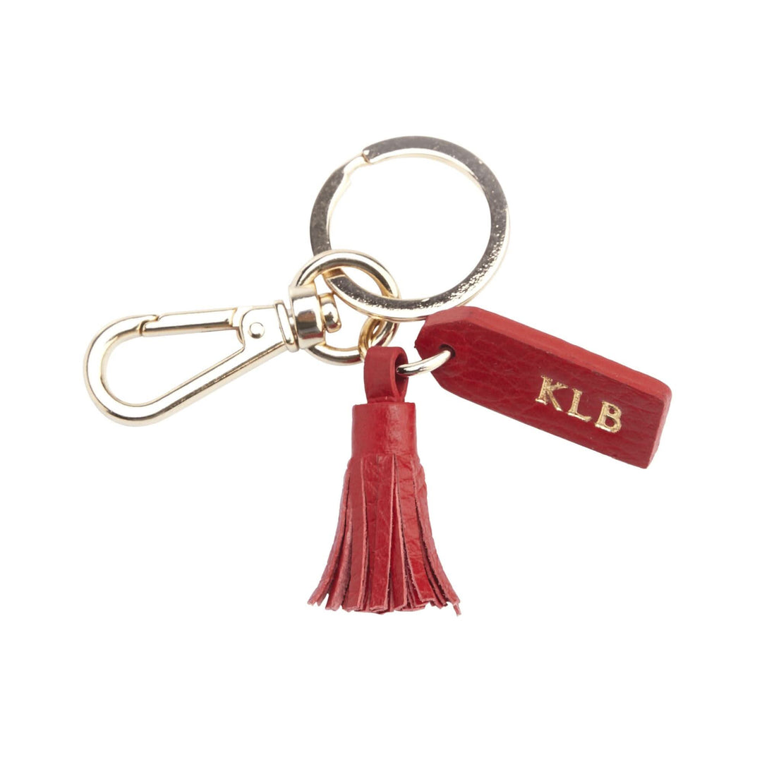 Mini tassel key fob with goldtone hardware and personalized tag, stylish key organizer for bags.