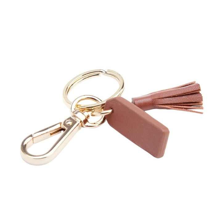 Mini tassel key fob with goldtone hardware, featuring a chic design for organizing keys.
