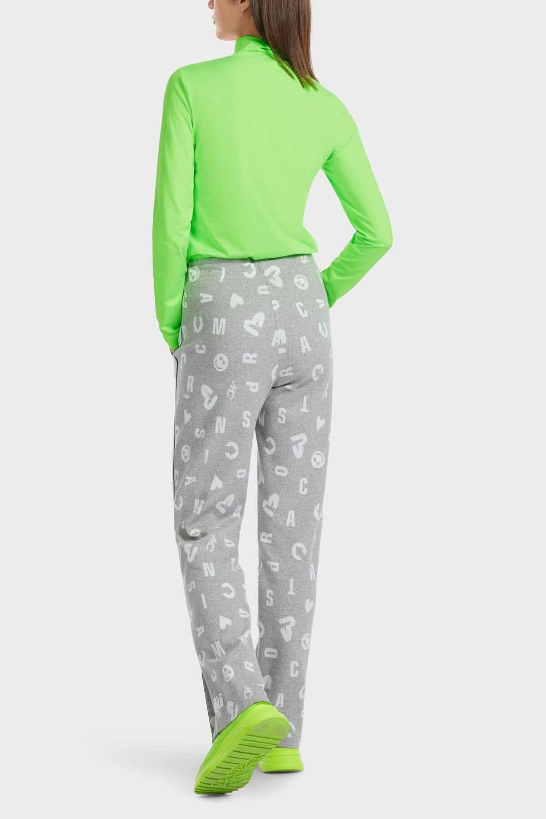 Femme portant un pantalon jogging Roanne en maille grise avec motifs colorés, vue arrière.