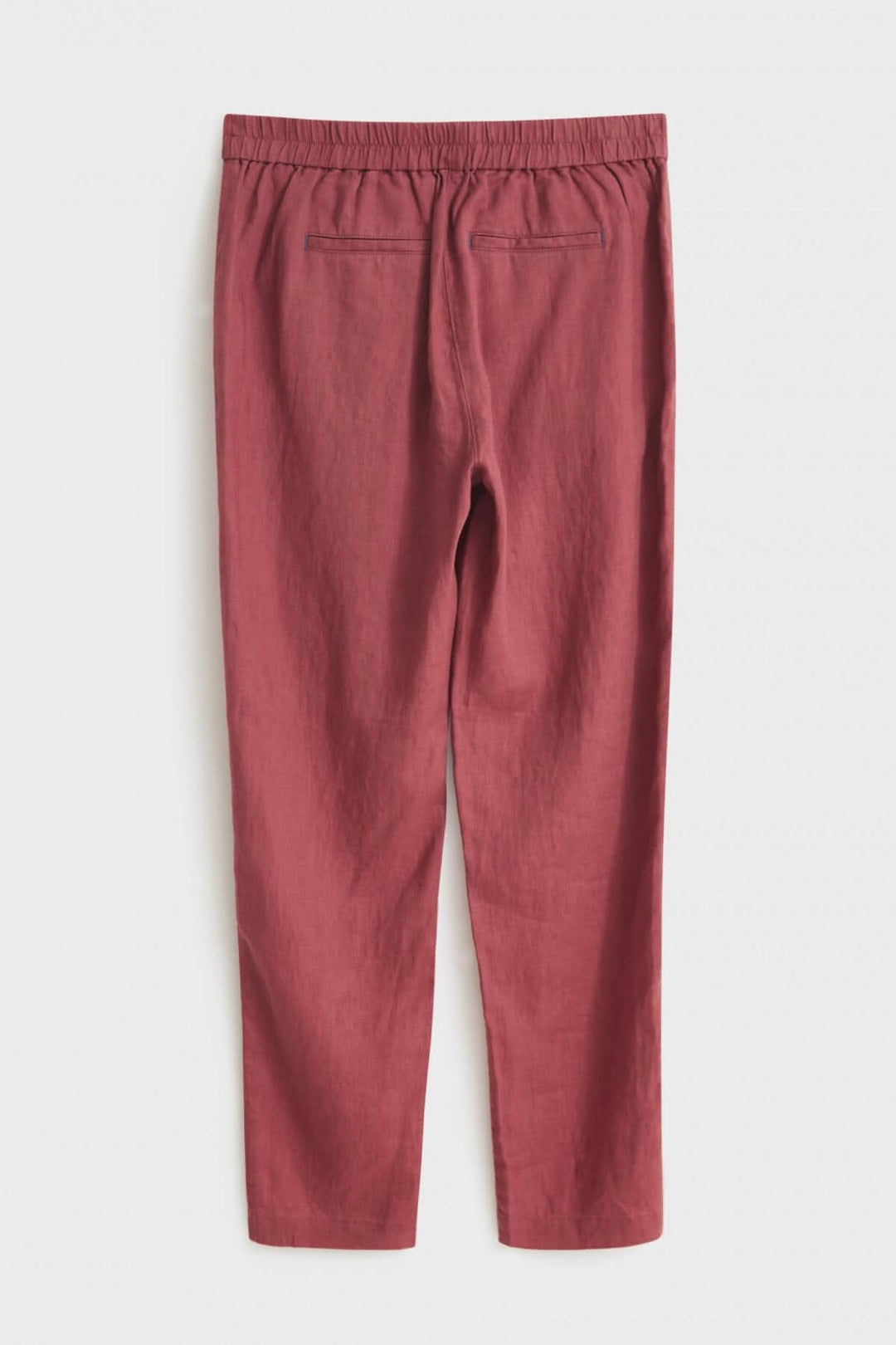 Pantalon Maddie en lin rose avec élastique au dos et poches latérales, idéal pour temps chaud.