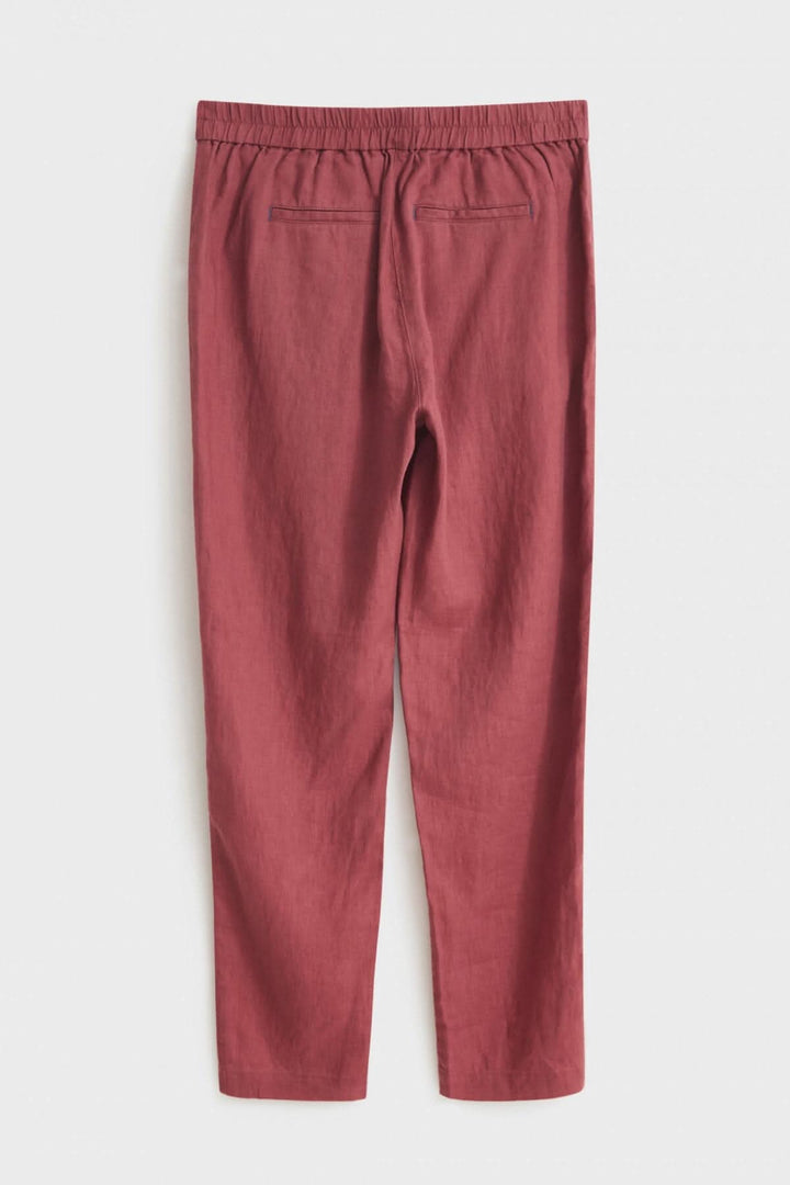Pantalon Maddie en lin rose avec élastique au dos et poches latérales, idéal pour temps chaud.