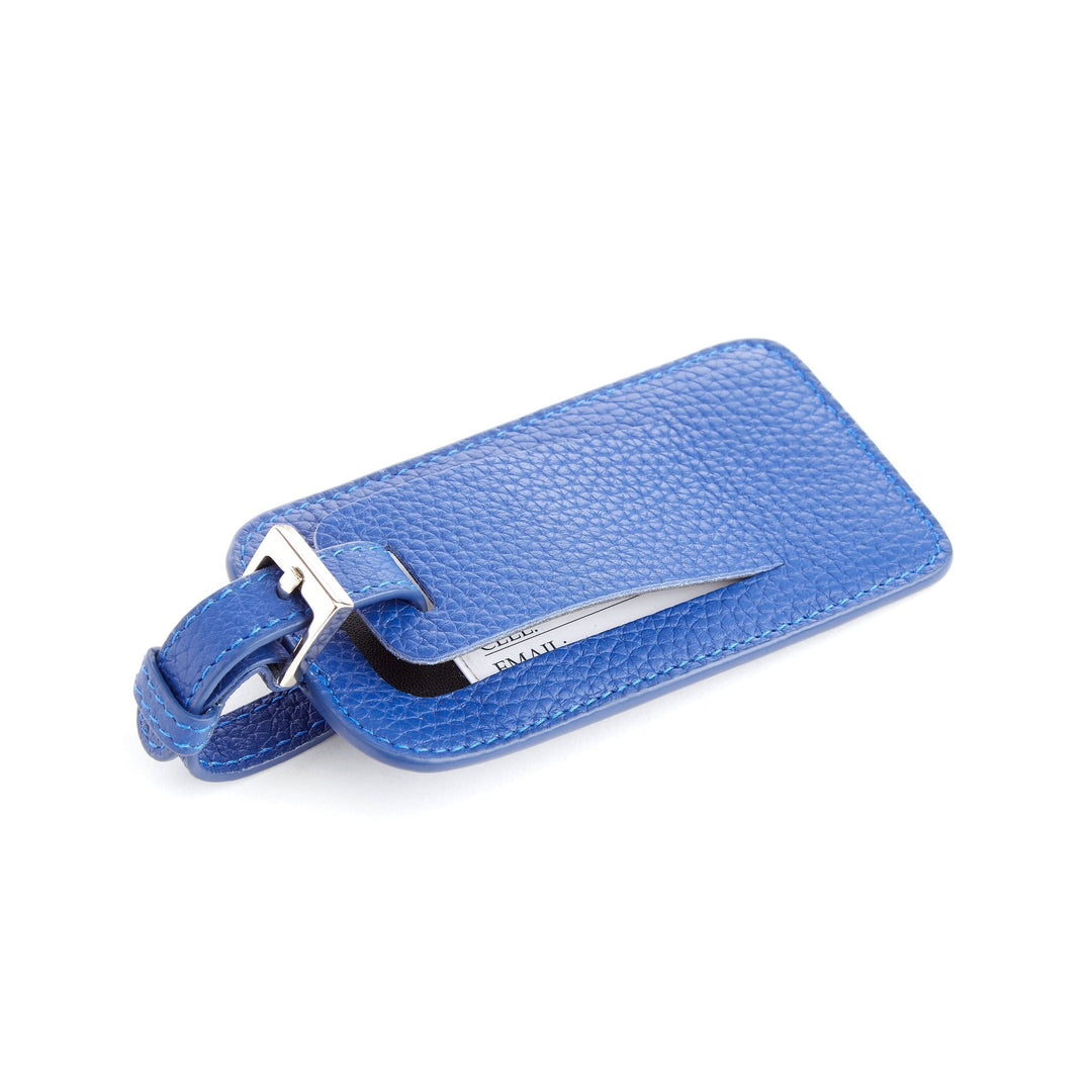 Étiquette à bagages en cuir bleu, design élégant et pratique pour le voyage.