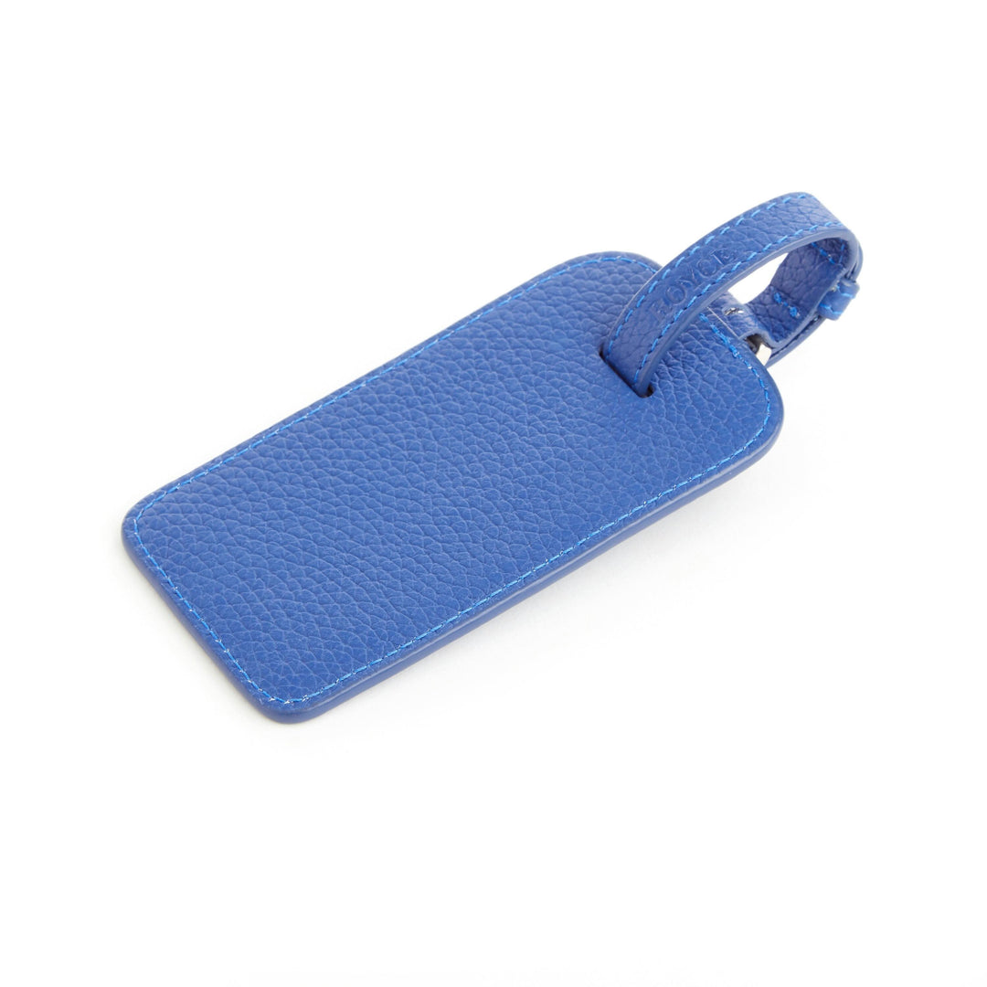 Étiquette à bagages en cuir américain bleu, élégante et durable pour un voyage stylé.