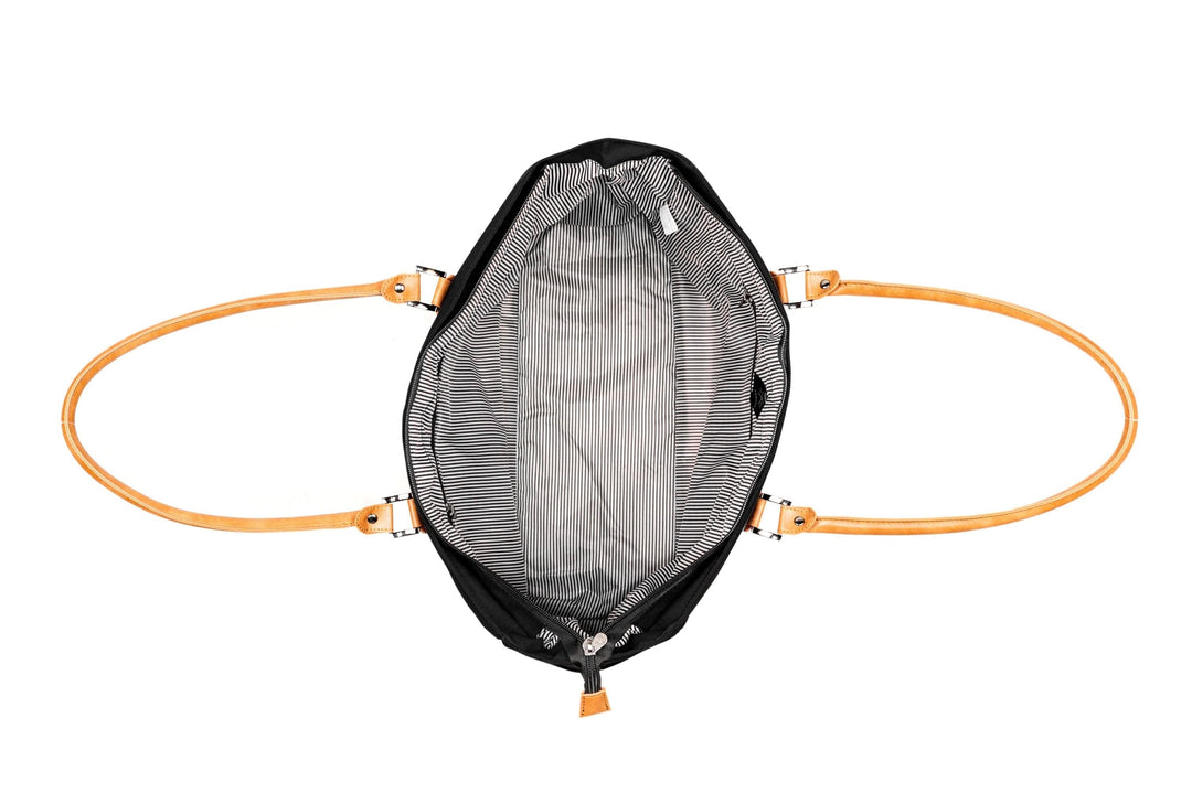 View of the interior of the PKG Georgian 33L tote bag showcasing the striped lining and faux leather straps.