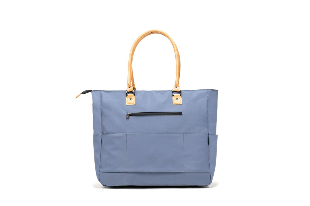 PKG Georgian 33L tote bag in blue with faux leather handles and multiple pockets for travel organization.