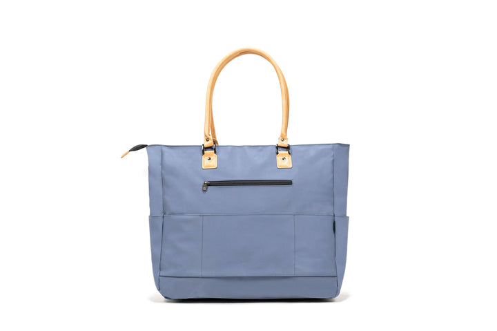 PKG Georgian 33L tote bag in blue with faux leather handles and multiple pockets for travel organization.