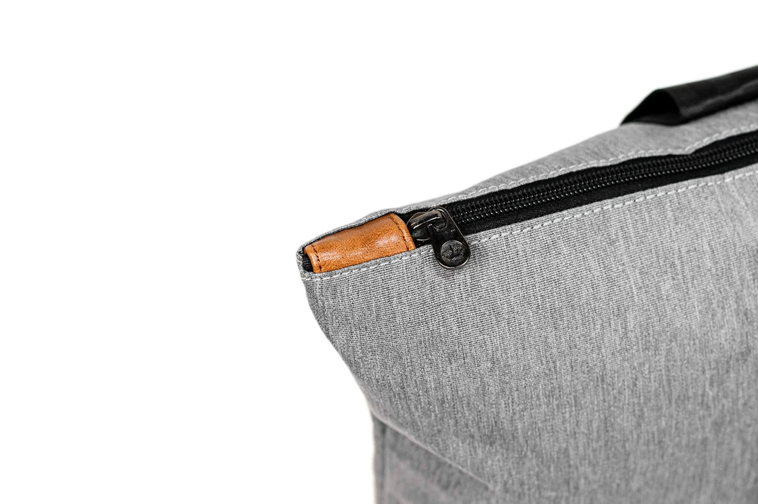 Close-up of the PKG Lawrence 16L tote bag's zipper detail with a leather pull tab.