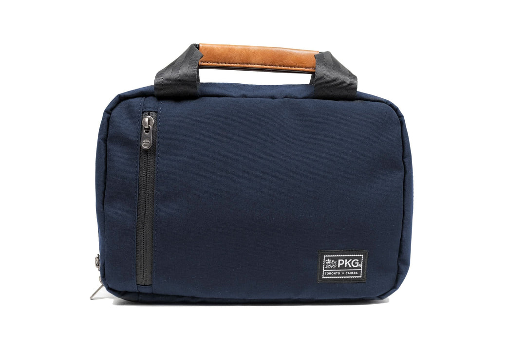 PKG Simcoe recycled essentials bag in navy blue with vegan leather accents and sturdy handle.