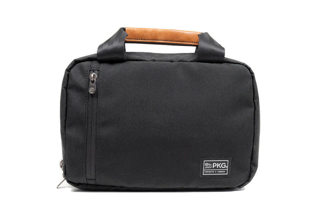 PKG Simcoe recycled essentials bag with vegan leather accents and weather-resistant fabric.