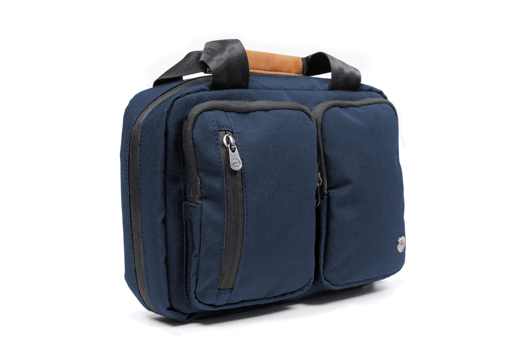 PKG Simcoe recycled accessories bag in navy blue, featuring multiple pockets and a vegan leather handle.