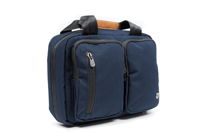 PKG Simcoe recycled accessories bag in navy blue, featuring multiple pockets and a vegan leather handle.