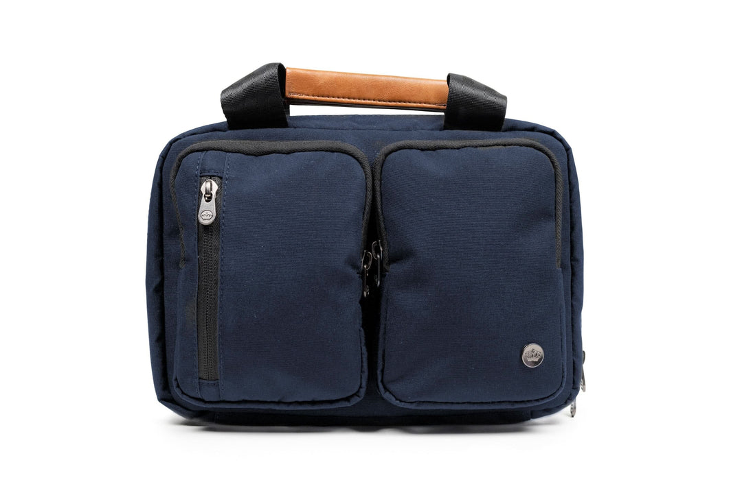 PKG Simcoe recycled essentials bag in navy with vegan leather handle and organized pockets for toiletries.