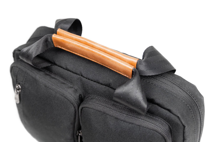 PKG Simcoe recycled essentials bag showcasing sleek design and vegan leather accents on handle.