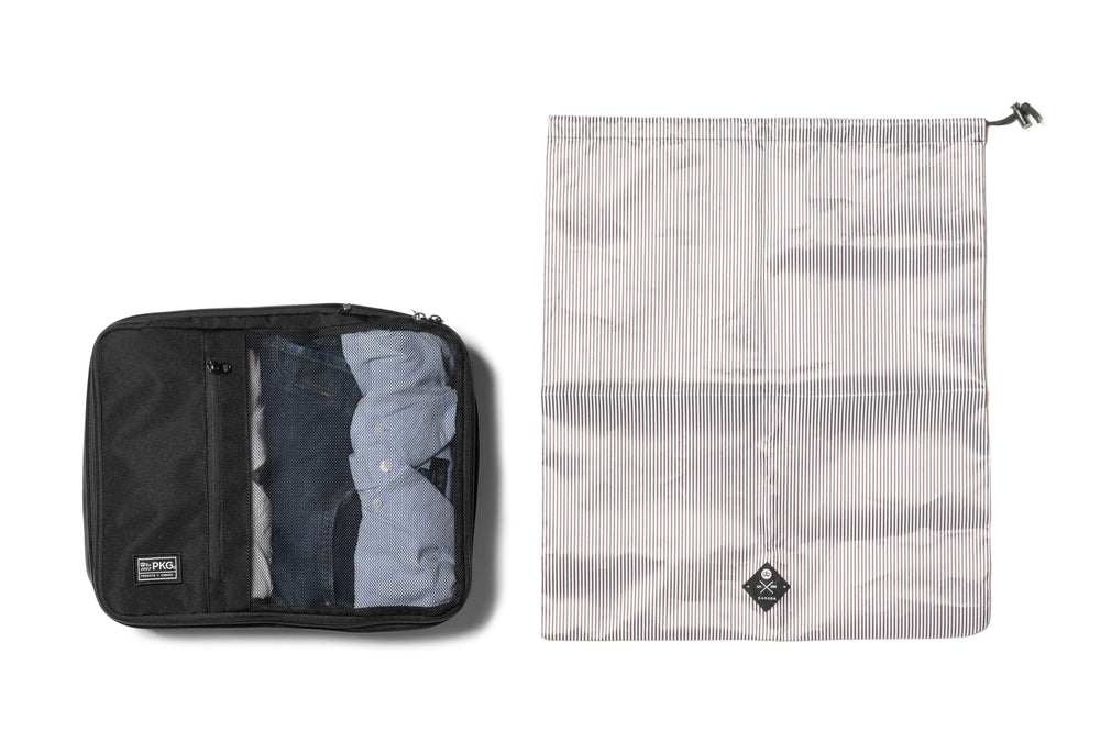 UNION 3-pack recycled compression packing cubes with laundry/shoe bag, showcasing organized clothing and travel essentials.