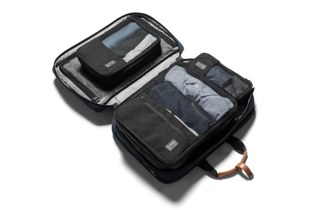 UNION Recycled Compression Packing Cubes - 3 Pack showing open bag with packed items and zippered compartments.