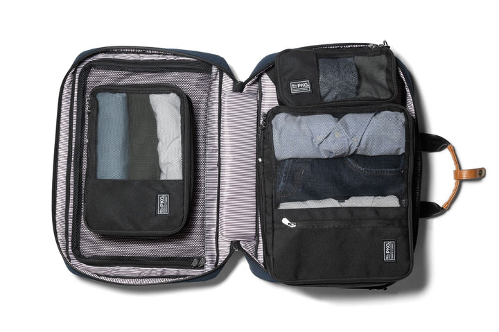 Union Recycled Compression Packing Cubes open, showcasing organized clothing and laundry/shoe bag for efficient packing.